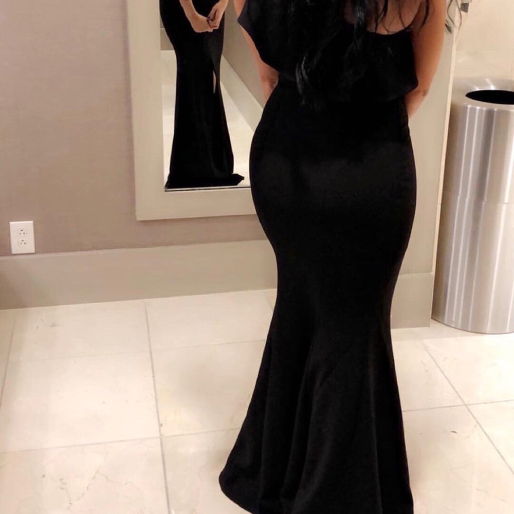 One ruffle shoulder long black dress with slit